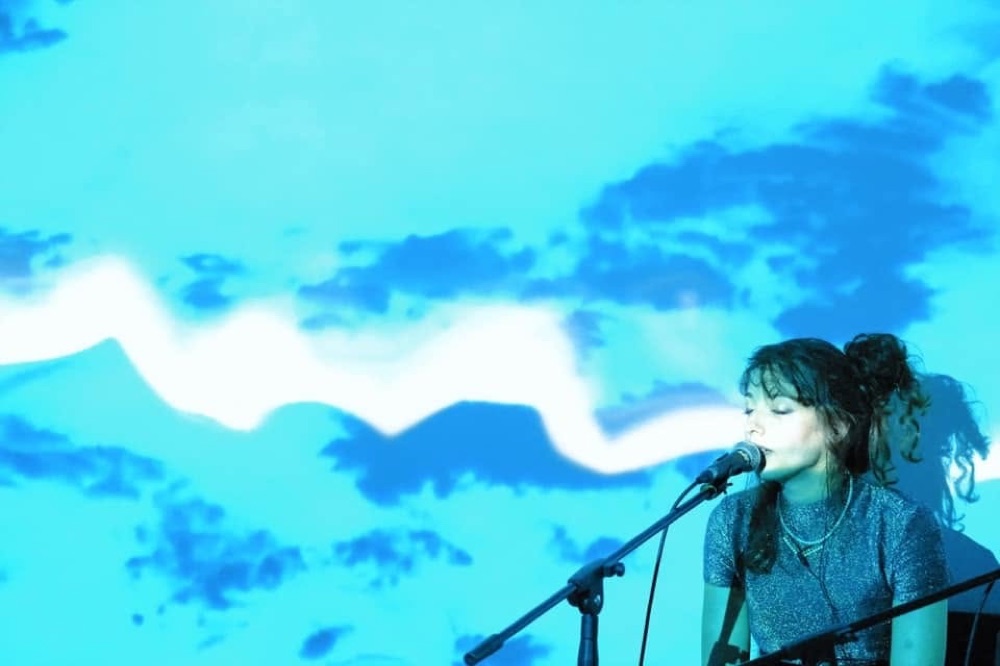 NINA singing live, blue stage light